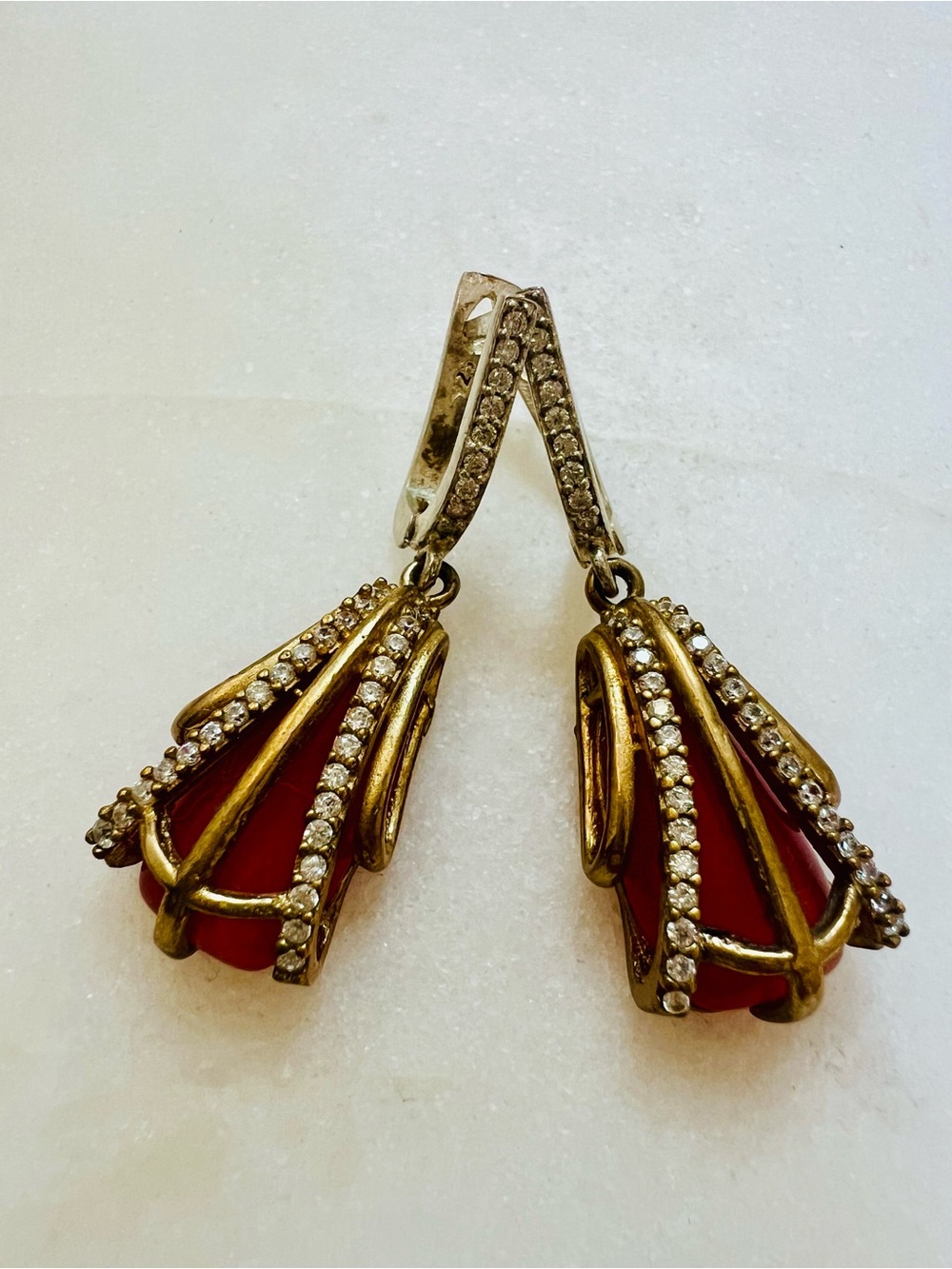 Beautiful hanging earrings with red stones in gold setting and little diamonds